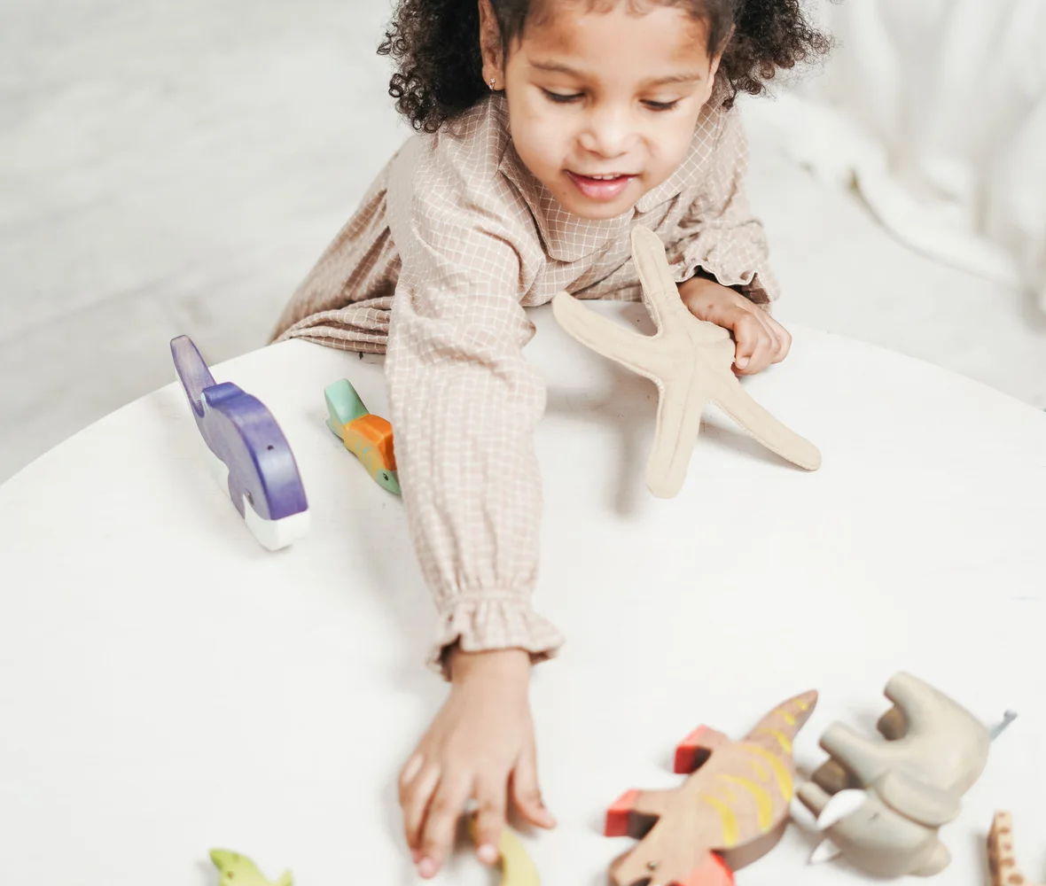 A happy child playing with colorful toys